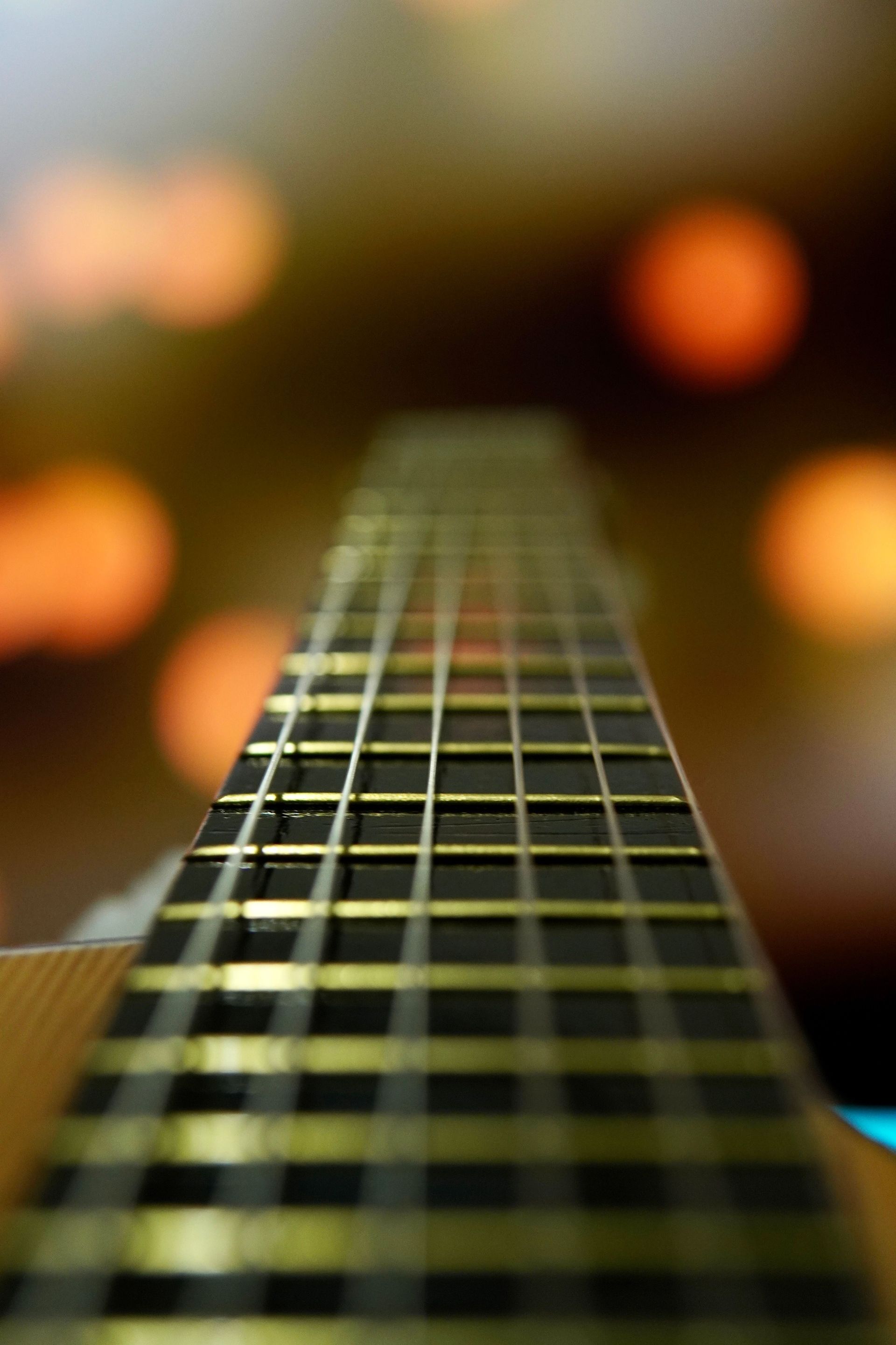 Detailed close-up of guitar strings with soft focus lighting. Ideal for music themes.